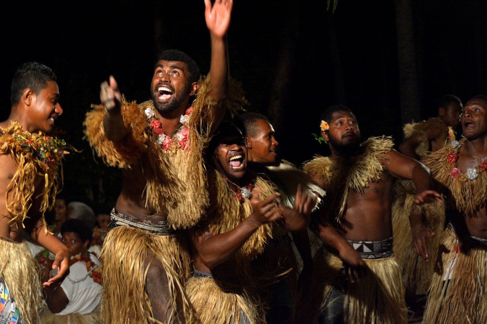 Fijian men dancing a traditional dance
