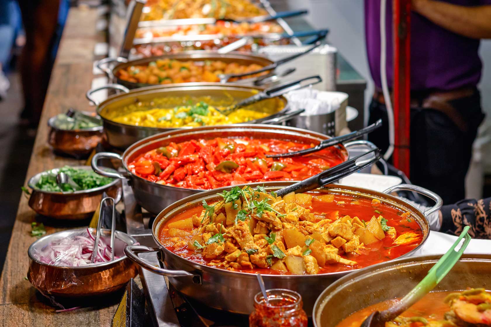 Cooked curries on display at Camden Market in London