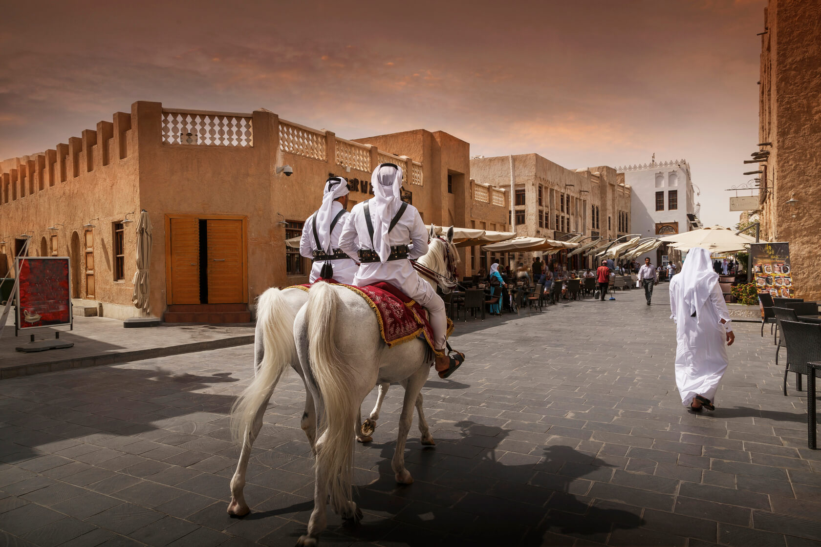 Men riding horses on Doha street, Doha, Qatar 