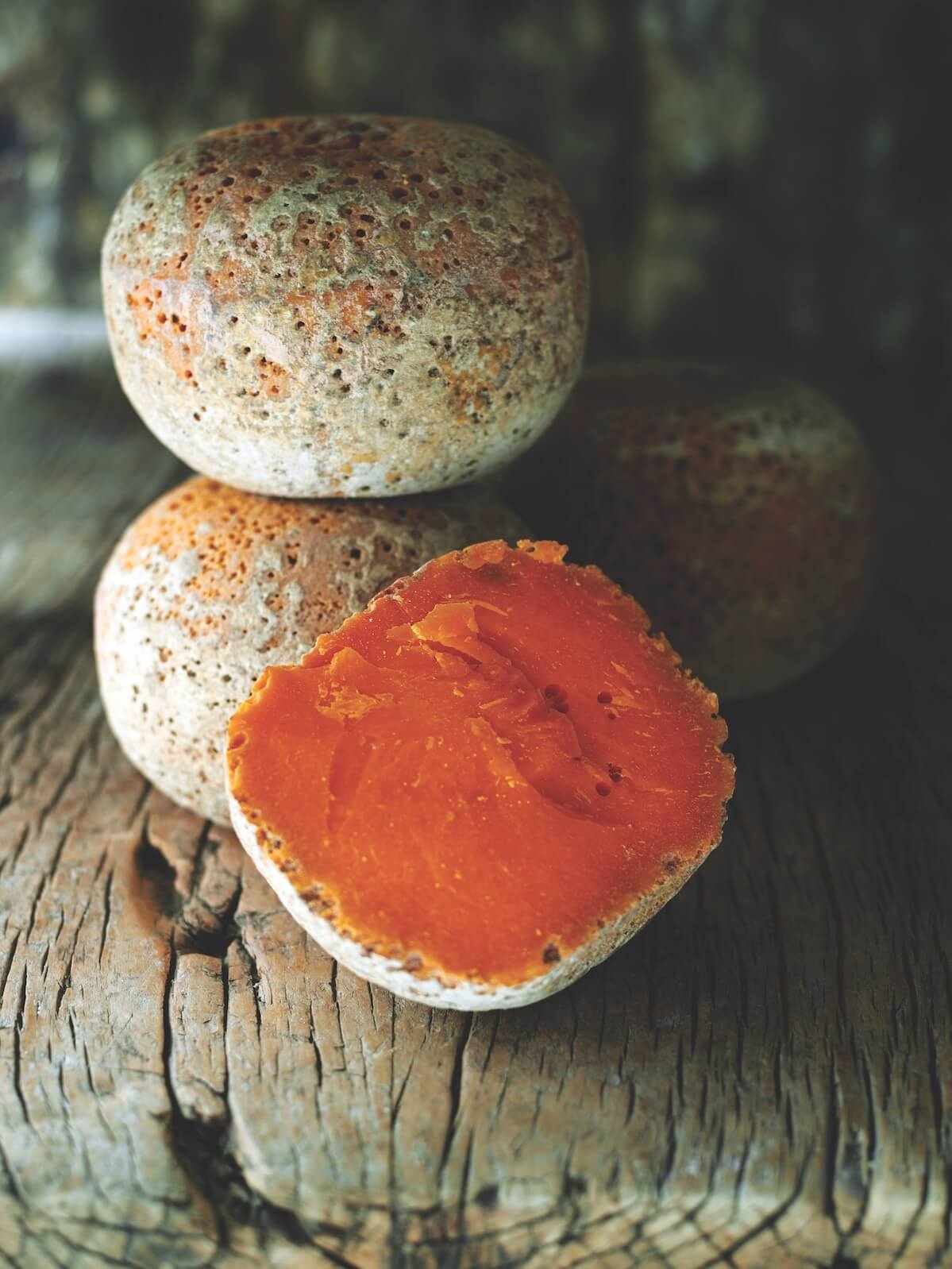 Mimolette cheese is stacked next to each other