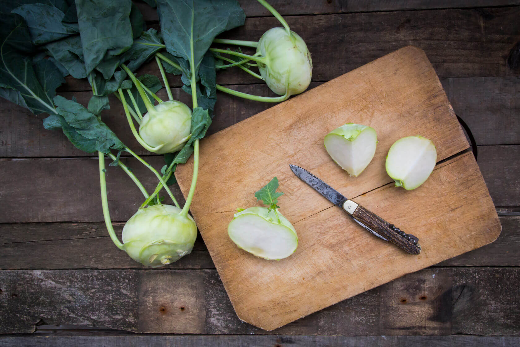 Fresh root vegetables on a cutting board cut in quarters
