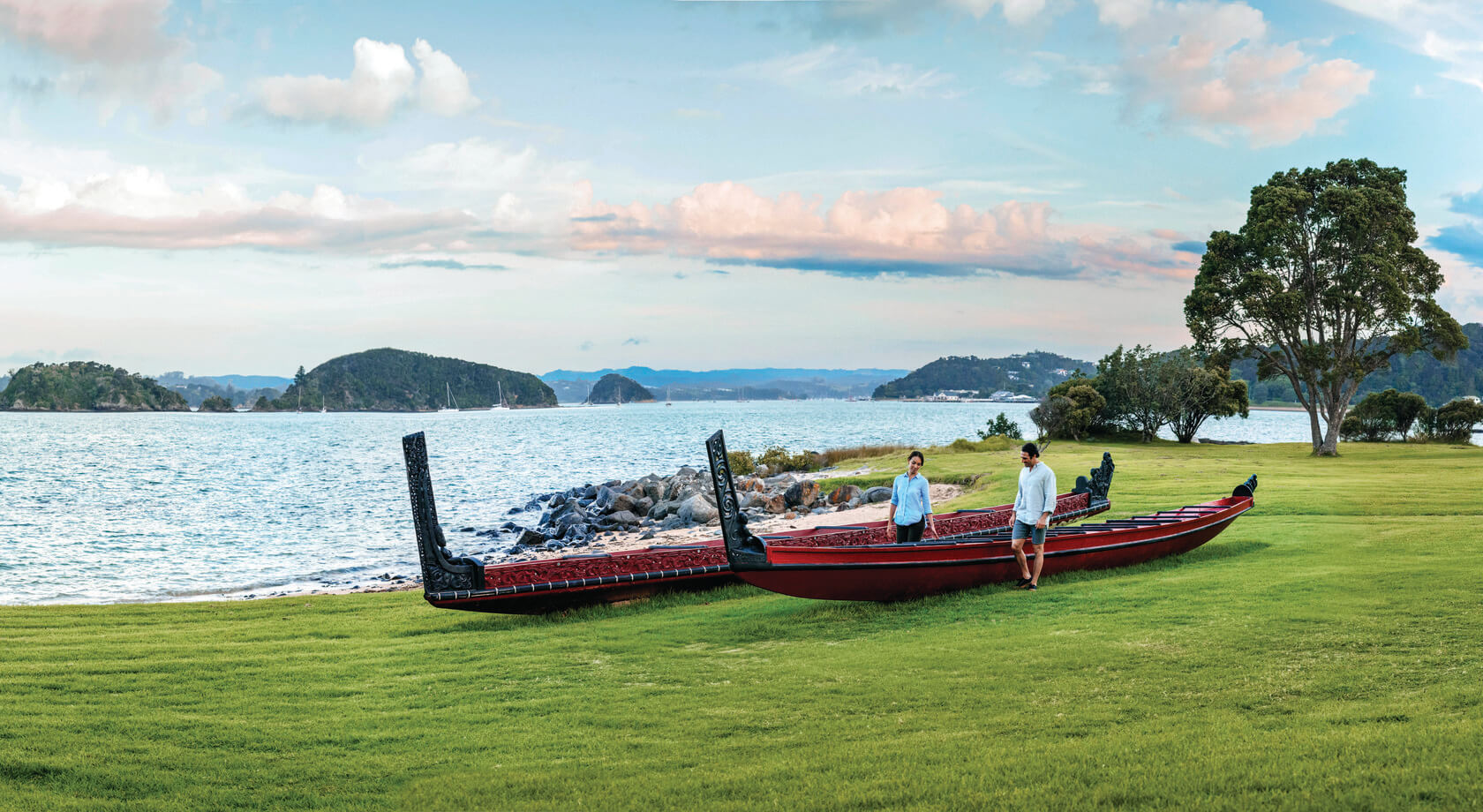 Two boats sit on a field. The boats are part of the Haka ritual